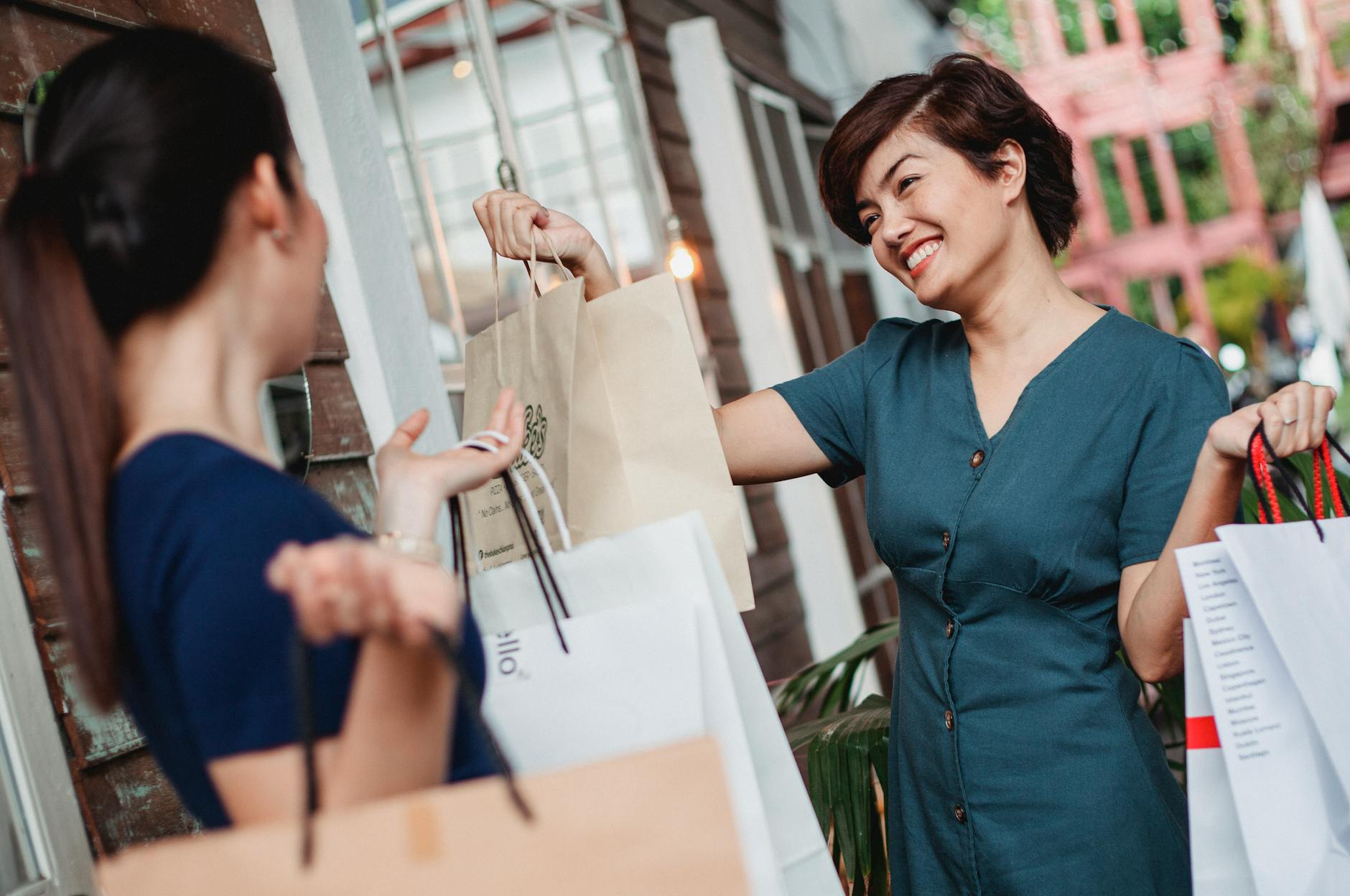 women carrying paper bags